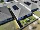 Aerial view of house, backyard with garden, and solar panels at 590 Tanaro Ln, Haines City, FL 33844