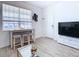 Casual dining area with modern table and three stools by window at 590 Tanaro Ln, Haines City, FL 33844