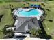 Aerial view of a community pool with surrounding lounge chairs at 590 Tanaro Ln, Haines City, FL 33844