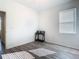 Bright bedroom featuring wood-look floors and a window with blinds at 590 Tanaro Ln, Haines City, FL 33844