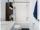 Clean bathroom with a shower/tub combo and white tile at 590 Tanaro Ln, Haines City, FL 33844