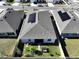 Aerial view of house with solar panels and backyard at 590 Tanaro Ln, Haines City, FL 33844