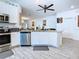 Modern kitchen with island, stainless steel appliances, and white cabinets at 590 Tanaro Ln, Haines City, FL 33844
