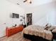 Bedroom with orange dresser, walk-in closet and mounted TV at 590 Tanaro Ln, Haines City, FL 33844