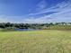 Scenic view of a lake and community from a grassy lot at 590 Tanaro Ln, Haines City, FL 33844