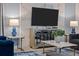 Living room with TV, modern furniture, and marble accent wall at 2901 Protagonist St, Kissimmee, FL 34746
