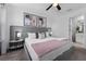 King-size bed in a bedroom with gray decor and modern art at 2901 Protagonist St, Kissimmee, FL 34746