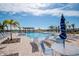 Relaxing pool area with lounge chairs, tables, and umbrella at 1991 Spring Shower Cir, Kissimmee, FL 34744