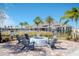 Community fire pit with seating and pool view at 1991 Spring Shower Cir, Kissimmee, FL 34744