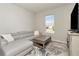 Light-filled Gathering room with gray sectional sofa and large window at 1991 Spring Shower Cir, Kissimmee, FL 34744