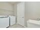 Laundry room with washer, dryer, and utility sink at 1991 Spring Shower Cir, Kissimmee, FL 34744