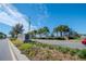 Community entrance with palm trees and signage at 1991 Spring Shower Cir, Kissimmee, FL 34744