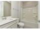 Clean bathroom with a shower/tub combo and vanity with a quartz countertop at 1991 Spring Shower Cir, Kissimmee, FL 34744