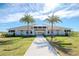 Community clubhouse with palm trees and walkway at 1991 Spring Shower Cir, Kissimmee, FL 34744