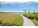 Scenic walking path alongside a pond and community homes at 1991 Spring Shower Cir, Kissimmee, FL 34744