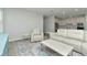 Open concept living room with beige leather sectional sofa and view into kitchen at 1991 Spring Shower Cir, Kissimmee, FL 34744
