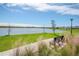 Peaceful lakefront view with a park bench and grassy area at 1991 Spring Shower Cir, Kissimmee, FL 34744