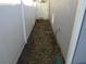 Narrow side yard with a gate and space for storage at 2608 Whitewood Road, Mulberry, FL 33860