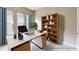 Home office with large desk, built-in shelving, and plenty of natural light at 128 Mosaic Blvd, Daytona Beach, FL 32124