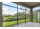 Spacious screened porch overlooking a lush green backyard at 128 Mosaic Blvd, Daytona Beach, FL 32124