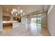 Bright dining room with large chandelier and access to the patio at 128 Mosaic Blvd, Daytona Beach, FL 32124