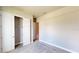 Well-lit bedroom featuring a double door closet and carpet flooring at 128 Mosaic Blvd, Daytona Beach, FL 32124