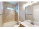 Clean bathroom with beige tile, a bathtub, and a vanity with a quartz countertop at 128 Mosaic Blvd, Daytona Beach, FL 32124