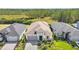 Aerial view of three homes with gray roofs and two-car garages at 128 Mosaic Blvd, Daytona Beach, FL 32124