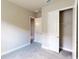 Simple bedroom with neutral walls, carpet flooring, and a double-door closet at 128 Mosaic Blvd, Daytona Beach, FL 32124