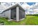 Corner screened porch with gray stucco exterior and a view of the backyard and trees at 128 Mosaic Blvd, Daytona Beach, FL 32124