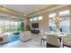 Bright dining area and living room with a view of the backyard and a large TV at 128 Mosaic Blvd, Daytona Beach, FL 32124
