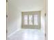 Bright bedroom with neutral walls, tile flooring, and three windows at 128 Mosaic Blvd, Daytona Beach, FL 32124