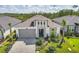 One-story house with gray siding, brown roof, and a screened porch in a residential neighborhood at 128 Mosaic Blvd, Daytona Beach, FL 32124