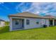 Home features a covered patio and a nice green backyard at 3327 Chinotto Dr, Lake Alfred, FL 33850