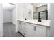 Bathroom boasts double vanity, white cabinets, and black matte hardware at 3327 Chinotto Dr, Lake Alfred, FL 33850