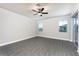 Spacious bedroom with wood-look floors and ceiling fan at 3327 Chinotto Dr, Lake Alfred, FL 33850