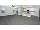 Open living space with kitchen, wood-look floors, and access to patio at 3327 Chinotto Dr, Lake Alfred, FL 33850