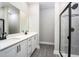 Modern bathroom with double vanity, quartz countertop and walk-in shower at 3327 Chinotto Dr, Lake Alfred, FL 33850