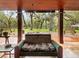 Serene covered patio with comfortable seating and a view of the expansive backyard at 10820 Sw 31St Way, Webster, FL 33597