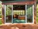 Enclosed hot tub area with large windows and a wooden deck at 10820 Sw 31St Way, Webster, FL 33597