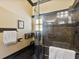 Modern bathroom with granite shower and black fixtures at 10820 Sw 31St Way, Webster, FL 33597
