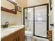 Bathroom with granite countertop, shower, and toilet at 10820 Sw 31St Way, Webster, FL 33597