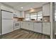 Updated kitchen boasts white cabinets, granite counters, and modern appliances at 1610 Reynolds Rd # 5, Lakeland, FL 33801