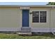 Mobile home exterior with blue door and stone steps at 1610 Reynolds Rd # 5, Lakeland, FL 33801