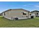 Mobile home exterior with light yellow siding and air conditioning unit at 1610 Reynolds Rd # 5, Lakeland, FL 33801