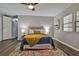 Main bedroom with a comfy bed and wood-look floors at 1610 Reynolds Rd # 5, Lakeland, FL 33801