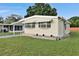 Landscaped manufactured home with awning and steps at 1610 Reynolds Rd # 5, Lakeland, FL 33801