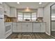 Modern kitchen with white cabinets, granite countertops, and a bay window at 1610 Reynolds Rd # 5, Lakeland, FL 33801