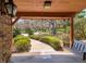 View from porch shows a landscaped yard and mature trees at 8723 A D Mims Rd, Orlando, FL 32818