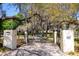 Private gated entrance to property with lush landscaping at 8723 A D Mims Rd, Orlando, FL 32818